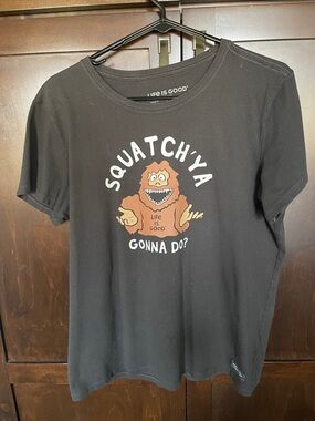 Life Is Good Black Tee with brown Sasquatch Graphic, size large.